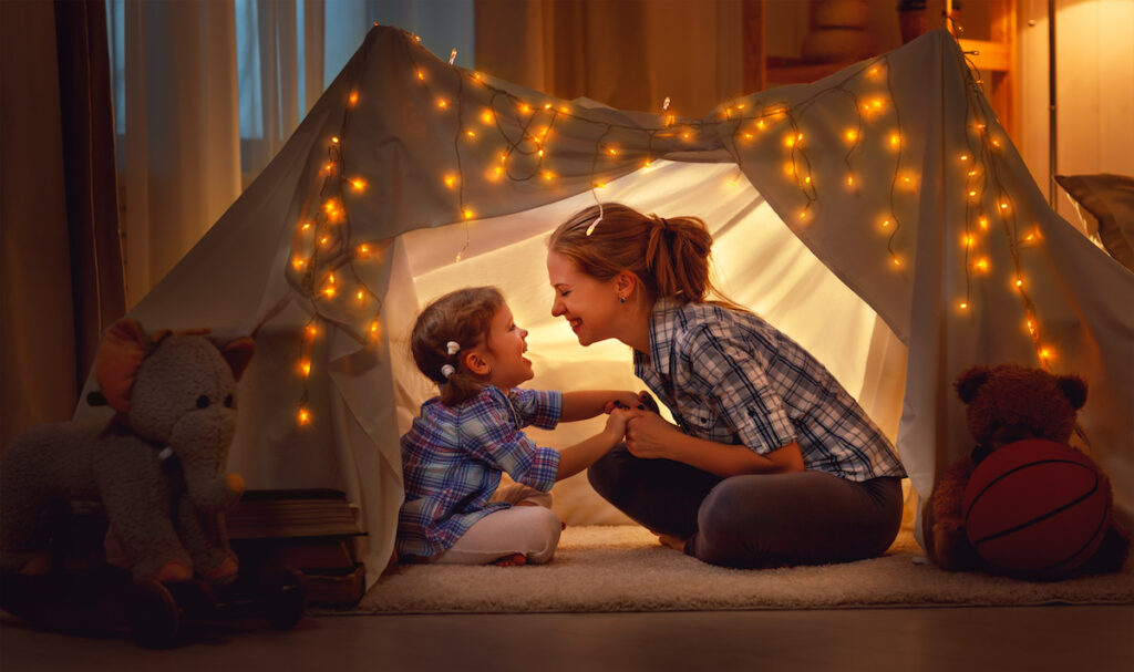 mom and daughter playing in tent